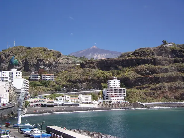 Playa de San Marcos beach in Tenerife, featuring a sandy shoreline with moderate water conditions, certified with Blue Flag status for environmental quality