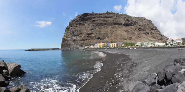 Playa de El Puerto beach in La Palma, featuring a sandy shoreline with calm water conditions, certified with Blue Flag status for environmental quality