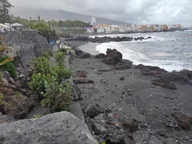 Playa Charcón beach in Tenerife, featuring a sandy shoreline with calm water conditions