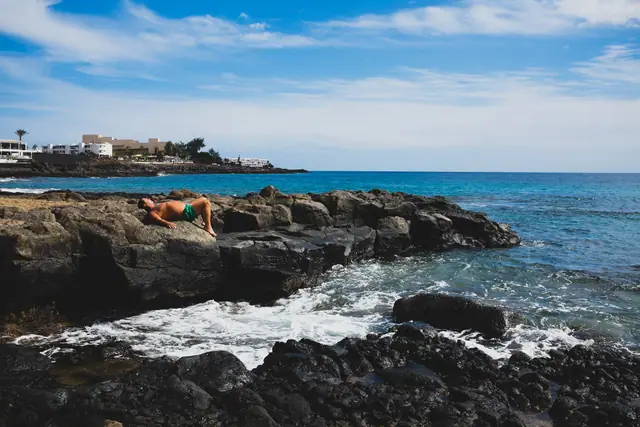 Las Cucharas beach in Lanzarote, featuring a sandy shoreline with surfable water conditions