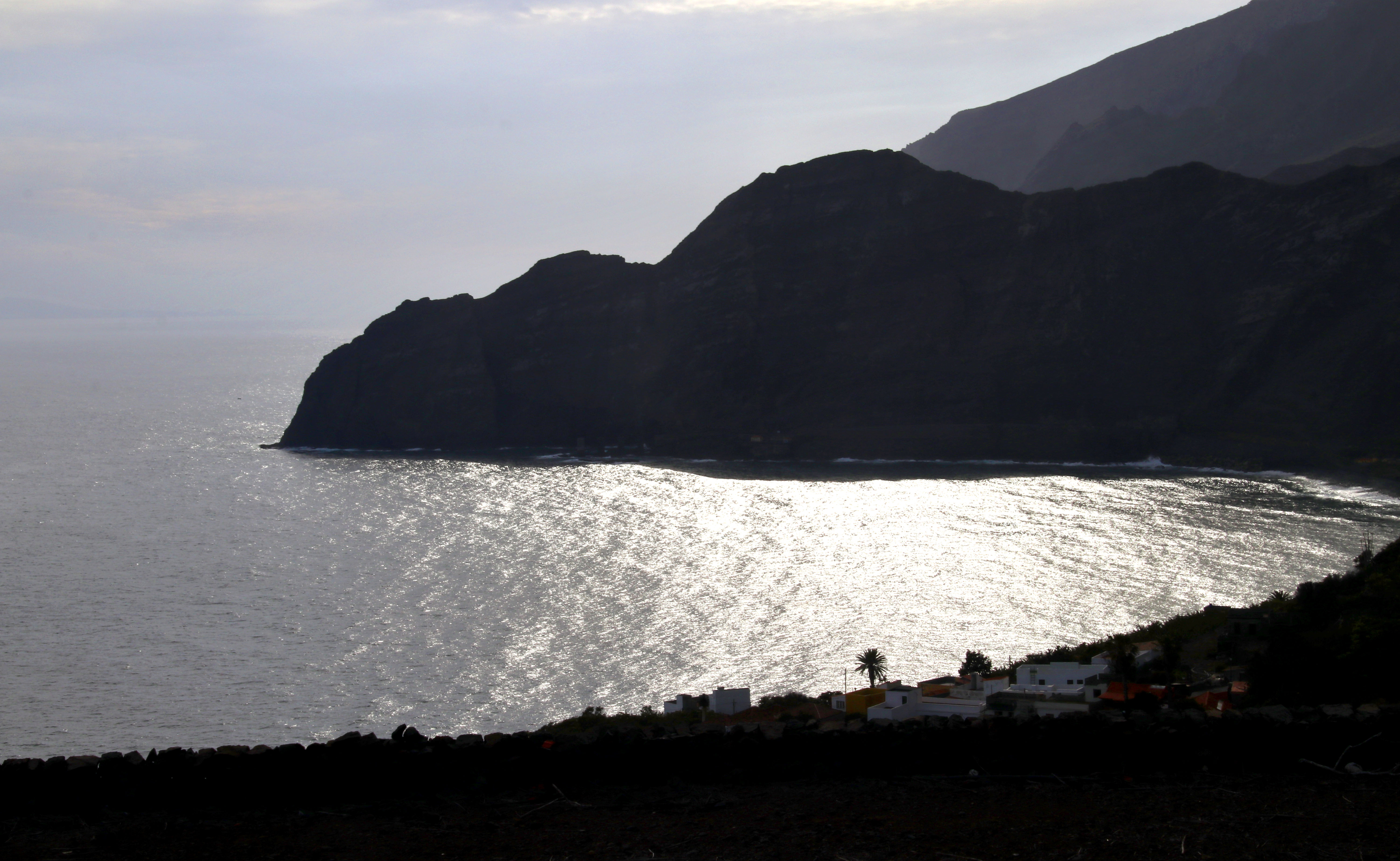 Playa de Agulo beach in La Gomera, featuring a pebbly shoreline with wavy water conditions