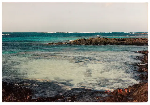 Playa la Barra beach in Fuerteventura, featuring a sandy shoreline with wavy water conditions