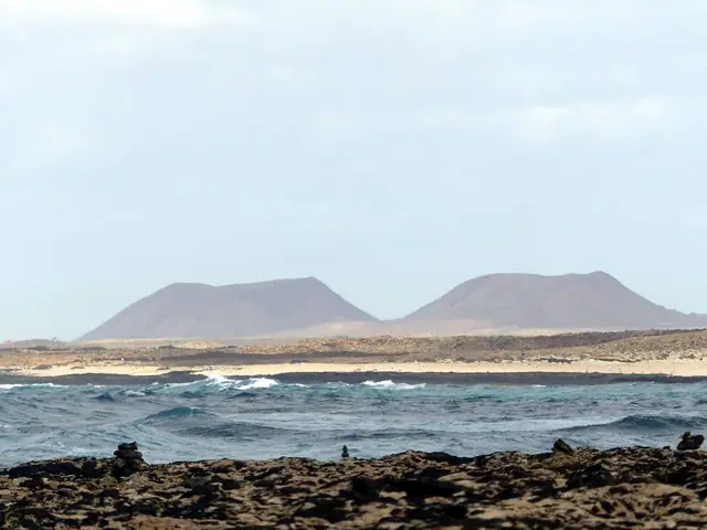 Punta Gorda beach in Fuerteventura, featuring a sandy shoreline with surfable water conditions