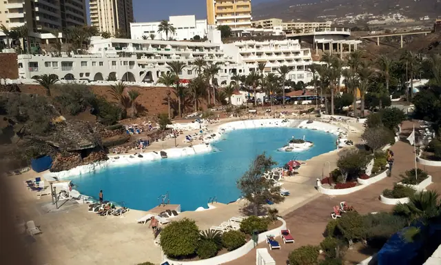 Playa las Salinas beach in Tenerife, featuring a pebbly shoreline with calm water conditions