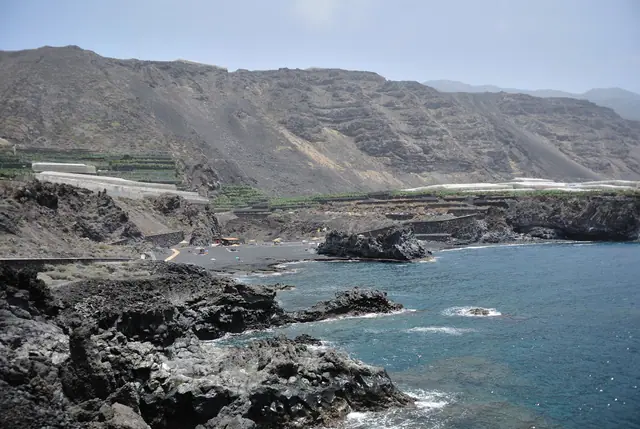 Playa de Los Monjas beach in La Palma, featuring a pebbly shoreline with moderate water conditions