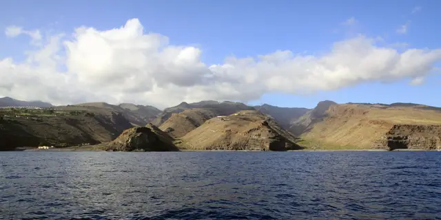 Playa del Medio beach in La Gomera, featuring a pebbly shoreline with moderate water conditions