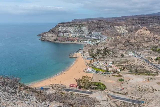 Playa de Tauro beach in Gran Canaria, featuring a sandy shoreline with calm water conditions