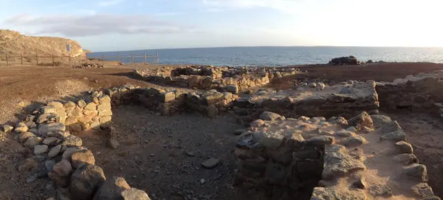 Playa de las Pimientas beach in Gran Canaria, featuring a pebbly shoreline with moderate water conditions