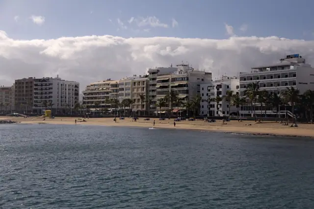 Playa del Reducto beach in Lanzarote, featuring a sandy shoreline with calm water conditions