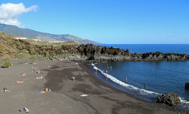 Playa los Cancajos beach in La Palma, featuring a sandy shoreline with calm water conditions, certified with Blue Flag status for environmental quality