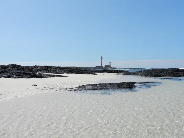 Punta Blanca beach in Fuerteventura, featuring a sandy shoreline with surfable water conditions