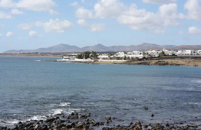 Playa del Cable beach in Lanzarote, featuring a sandy shoreline with calm water conditions