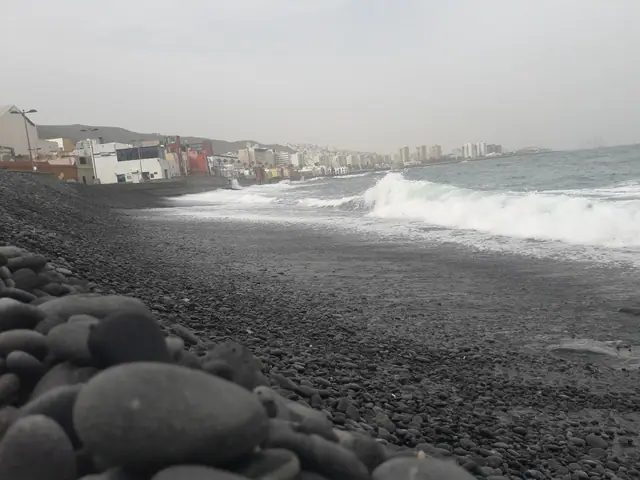 Playa de San Cristóbal beach in Gran Canaria, featuring a sandy shoreline with calm water conditions