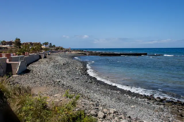 Playa de la Arenita beach in Tenerife, featuring a pebbly shoreline with moderate water conditions