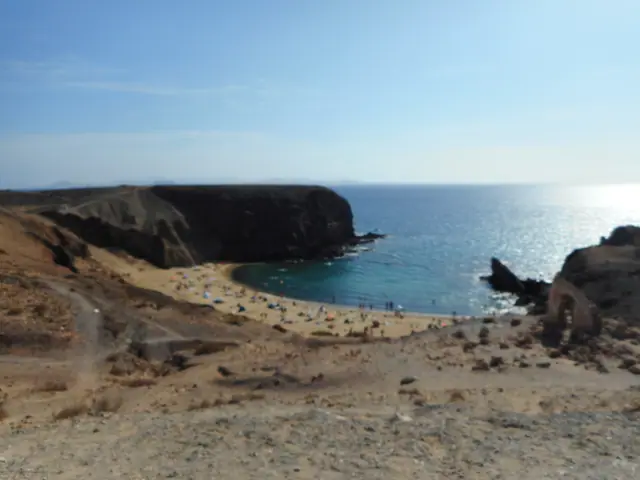 Caletón de San Marcial beach in Lanzarote, featuring a sandy shoreline with calm water conditions