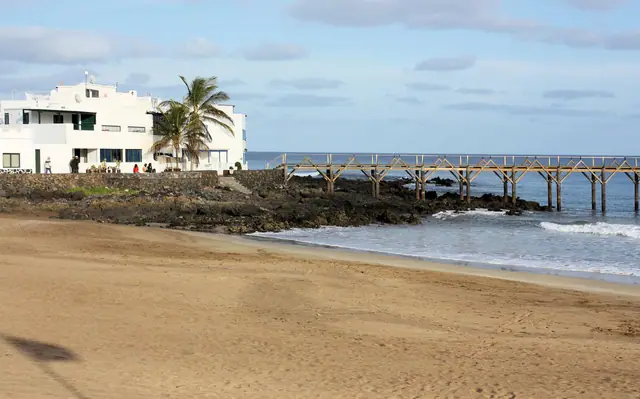 Sentry Box Beach in Lanzarote, featuring a sandy shoreline with moderate water conditions