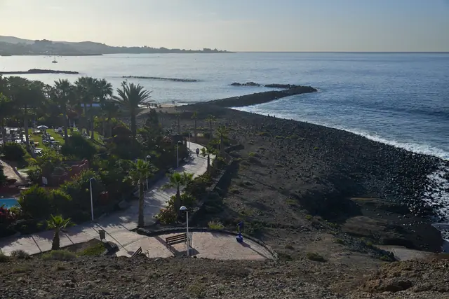 La Enramada beach in Tenerife, featuring a pebbly shoreline with moderate water conditions