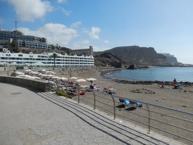 Playa del Cura beach in Gran Canaria, featuring a sandy shoreline with calm water conditions
