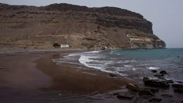 Playa de Veneguera beach in Gran Canaria, featuring a pebbly shoreline with moderate water conditions