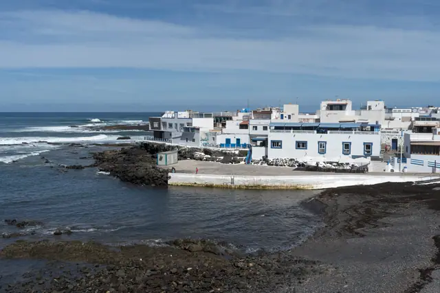 Caleta del Cotillo beach in Fuerteventura, featuring a pebbly shoreline with surfable water conditions