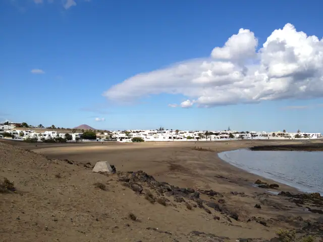 Playa la Concha beach in Lanzarote, featuring a sandy shoreline with moderate water conditions