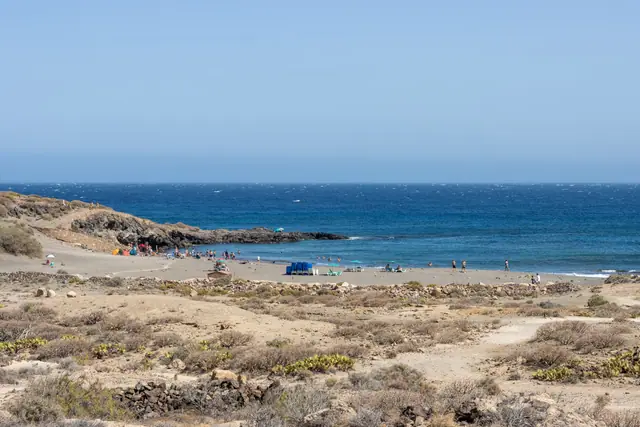 Playa Cardones beach in Tenerife, featuring a sandy shoreline with moderate water conditions