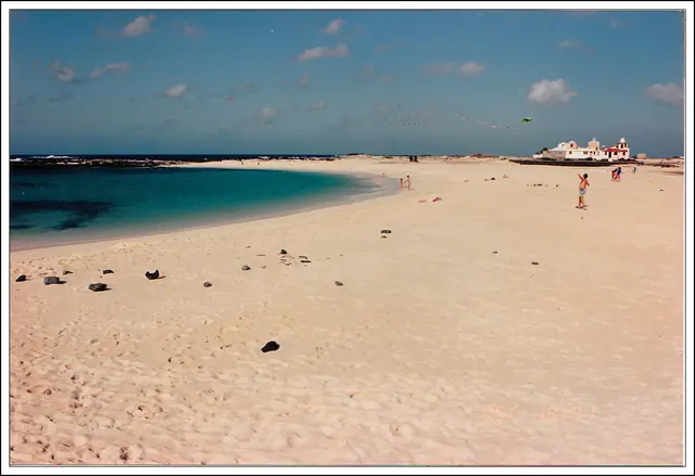 La Concha beach in Fuerteventura, featuring a sandy shoreline with calm water conditions, certified with Blue Flag status for environmental quality