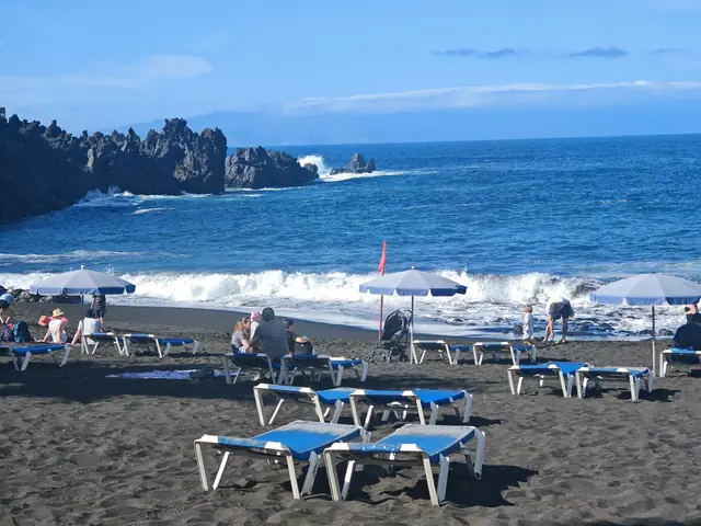 Playa de la Arena beach in Tenerife, featuring a sandy shoreline with calm water conditions