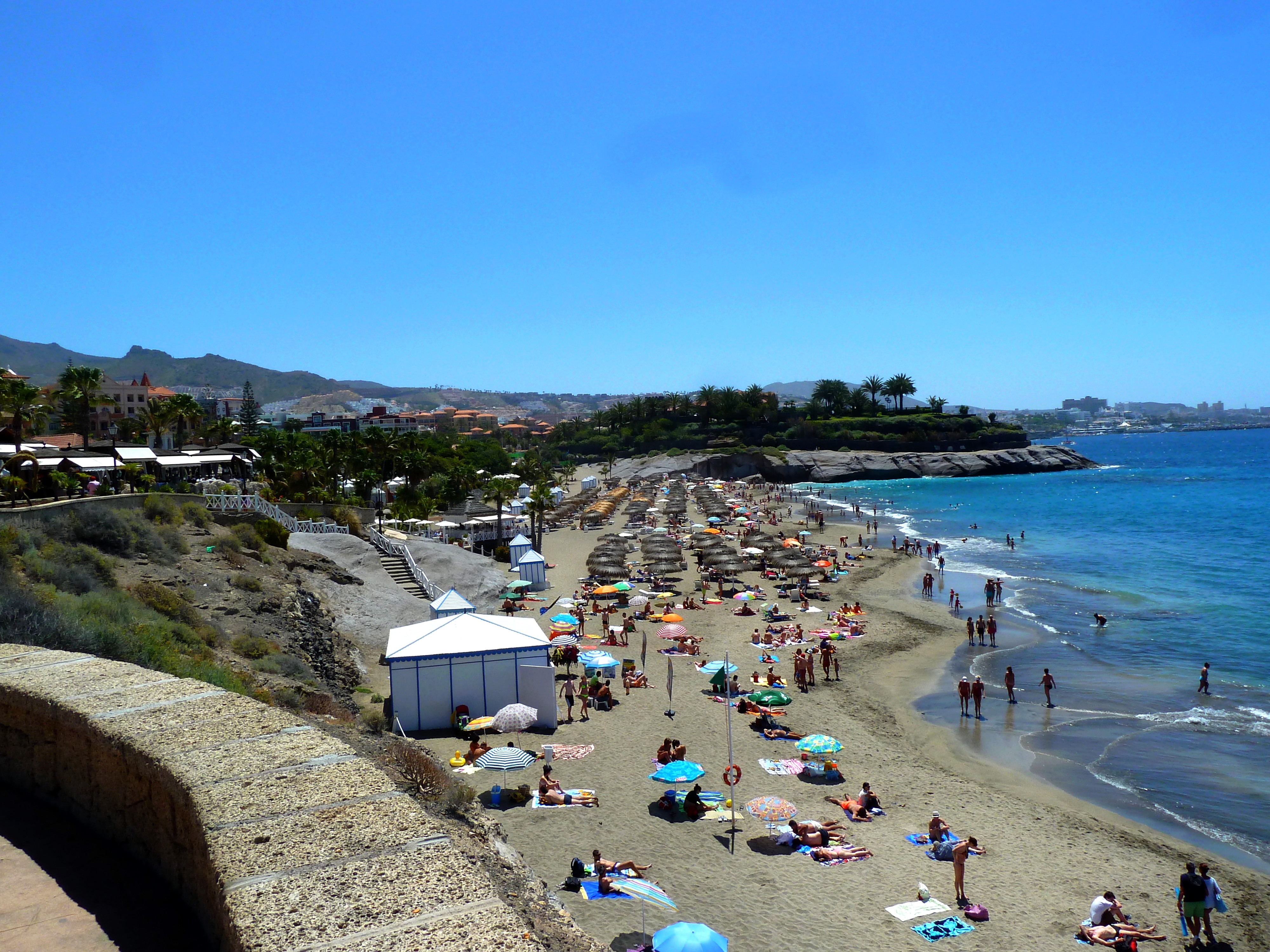 El Duque Norte beach in Tenerife, featuring a pebbly shoreline with calm water conditions