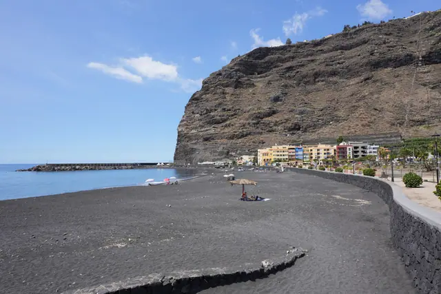 Playa de Tarajales beach in La Palma, featuring a sandy shoreline with calm water conditions