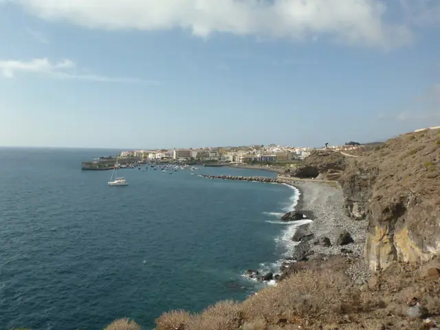 Playa de San Juan beach in Tenerife with calm water conditions, certified with Blue Flag status for environmental quality