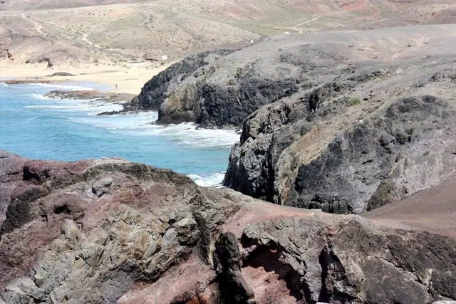 Playa del Pozo beach in Lanzarote, featuring a sandy shoreline with calm water conditions