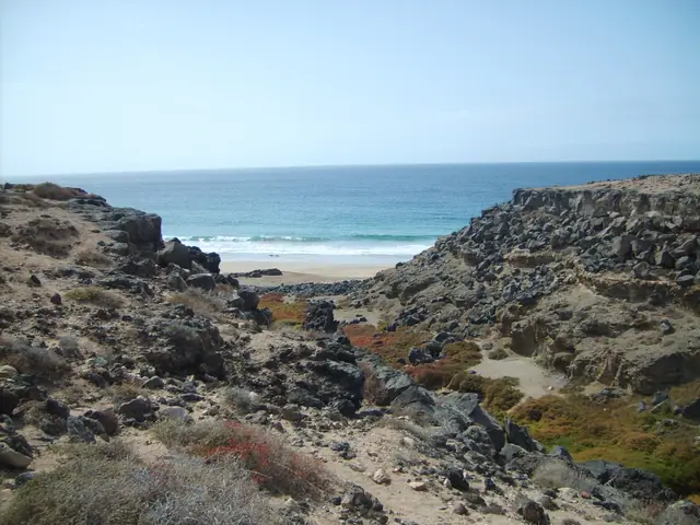 Playa de Tebeto beach in Fuerteventura, featuring a sandy shoreline with wavy water conditions