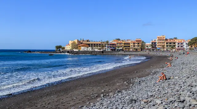 Playa La Calera beach in La Gomera, featuring a sandy shoreline with calm water conditions