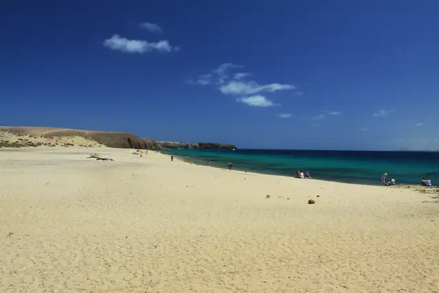 Playa Caleton del Cobre beach in Lanzarote, featuring a sandy shoreline with moderate water conditions