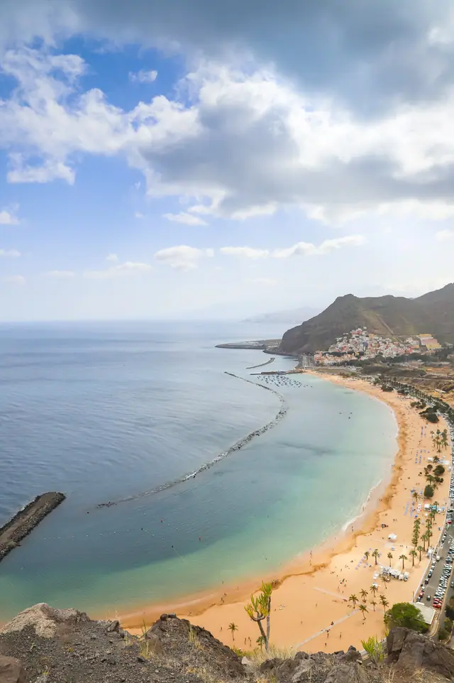 Playa de las Gaviotas beach in Tenerife, featuring a sandy shoreline with wavy water conditions