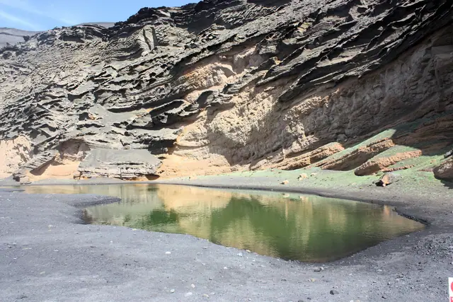 Playa de los Clicos beach in Lanzarote, featuring a sandy shoreline with calm water conditions